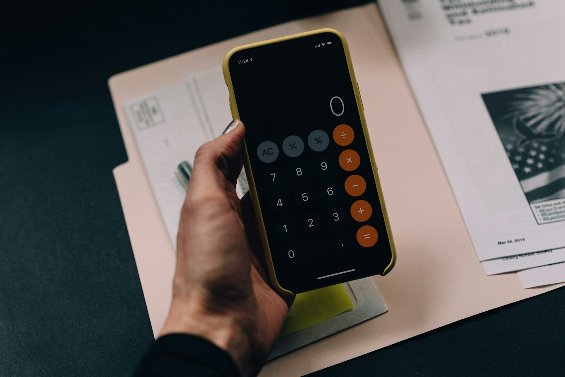 Accountant desk with financial documents, calculator, and laptop